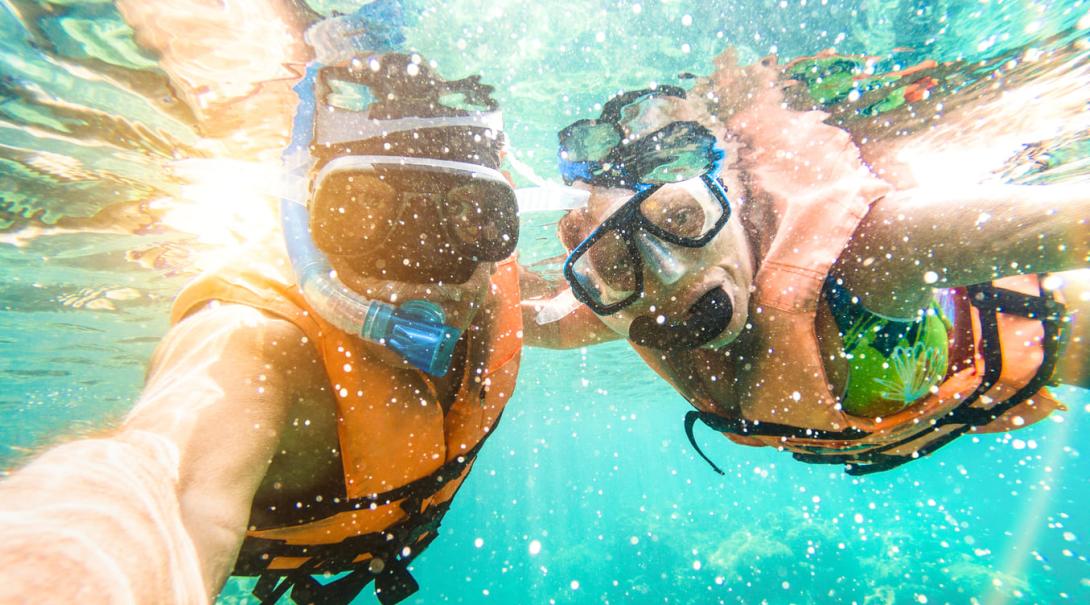 Discovery Tour travellers explore the underwater beauty in Fiji. A couple go snorkelling during their Authentic Adventure in Fiji.